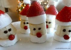 there are some santa hats made out of toilet paper rolls and strawberries on the table