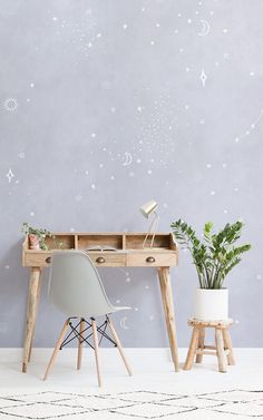 a desk and chair in front of a wall with stars