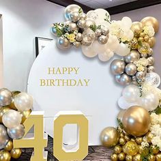 an image of a happy birthday sign with balloons and flowers on the front, surrounded by gold and silver decorations