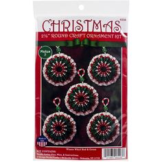 three christmas ornaments with red and green trimmings on the front of a package