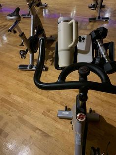 there are many exercise bikes on the floor in this gym room with hard wood floors