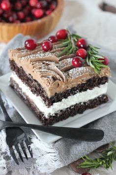 a piece of cake with frosting and cranberries on top