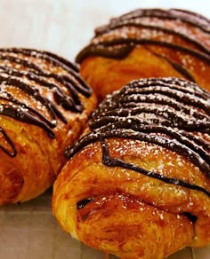 several pastries with chocolate drizzled on them