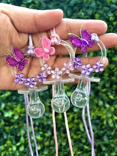 three purple and pink flowers are in the shape of wine glasses