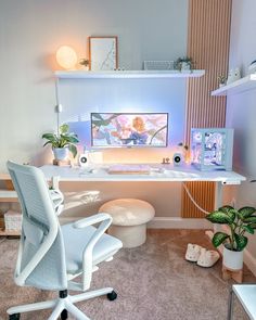 a white desk with a computer monitor and keyboard on it in front of a plant