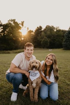 a man and woman pose for a photo with their dog