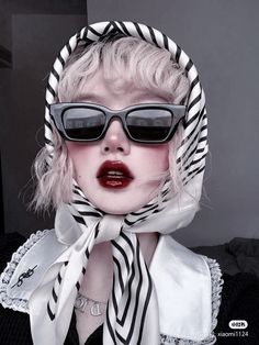 a woman with sunglasses and a scarf around her head