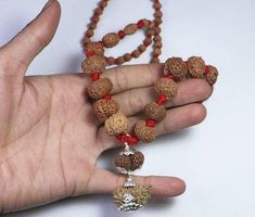 "Name: Rudraksha Siddha Mala Configuration: 1 to 14 mukhi + 1 Pcs Gaurishanker + 1 Pcs Ganesha Rudraksha. (Total: 16 Pcs) Origin: All Indonesian except 1 Mukhi Indian Quality: 100% Authentic - Superfine Note: Due to Natural Seed color varies from light brown to dark brown. Indonesian Siddha Mala- \"For the successful achievers and ambitious people who want to reach the top level, wearing of all 1 to 14 Mukhi Rudraksha is considered auspicious by the great epics. You may get everything what you c Red Spiritual Mala For Diwali, Navratri Gift Mala With Cutdana, Navratri Gift Cutdana Mala, Traditional Festive Mala For Meditation, Navratri Puja Cutdana Mala, Festival Rituals Mala With Cutdana, Cutdana Mala For Rituals And Festivals, Spiritual Festive Mala With Latkans, Spiritual Mala With Latkans For Festive Occasions