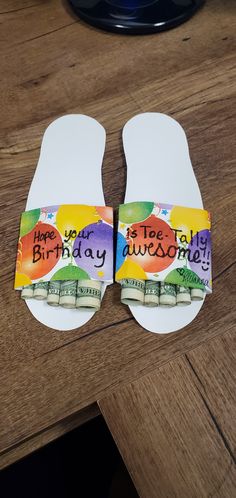 two flip flops with happy birthday written on them