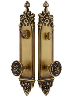 an ornately designed door handle with two knobs on each side and one in the middle