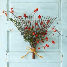 a bunch of red flowers sitting on top of a white door with paint swatches