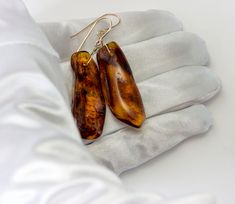 Natural Deep Rich Honey Amber drop earrings. Naturally super light weight to wear. Gemstone size is 13x43mm. Earrings hang 2 inches. These are free form long nuggets, they will vary only slightly pair to pair, all similar in shape and size. The mannequin shows the relative size and how they will hang. Characteristic inclusions inside that reflect light. Choose high quality sterling silver or 14k gold filled or 14k solid gold earwires - you pick the finish. Please check out my store for more gems Luxury Amber Citrine Earrings, Cheap Handmade Amber Earrings, Cheap Amber Drop Earrings, Cheap Amber Dangle Jewelry, Amber Earrings, Natural Amber, Earrings Sterling Silver, Sterling Earrings, Gemstone Earrings