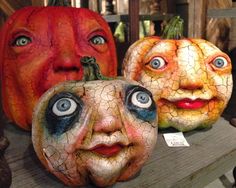 three pumpkins with faces painted on them