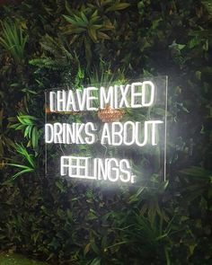 a neon sign that says i have mixed drinks about feelings on the side of a wall