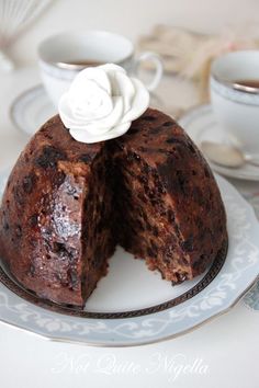 a chocolate cake on a plate with one piece cut out