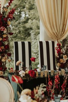 two black and white striped chairs sitting next to each other on top of a table