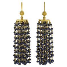 A fabulous pair of contemporary beaded sapphire tassel earrings! Crafted in 18kt yellow gold, each of these stylish earrings features a beveled gold disc that hangs from a simple earring wire. Attached on the underside of the discs are 27 strands of gold chain and a total of 243 sapphire beads on each earring. The sapphire beads display a deep blue hue, glistening with every movement, and beautifully framing the face. The earrings look lovely on and would be a wonderful addition to any fashion-f Sapphire Beads, Jewelry Design Drawing, Earring Wire, Stylish Earrings, Gold Disc, Stylish Earring, Design Drawing, Beaded Tassels, Yellow Sapphire