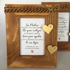 two wooden frames with hearts hanging from the sides, one has a poem written in spanish