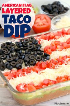 an american flag layered taco dip with black olives and tomatoes