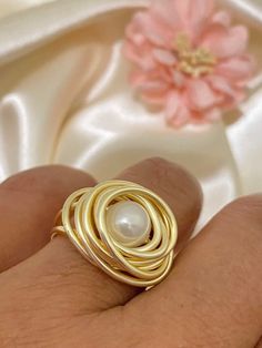 "Beautiful and Unique Gold Wire Wrapped Ring, ideal for an special gift for her, perfect to give any outfit a classic, feminine look. This modern pearl ring makes a great gift for bridesmaids and women of any age. This ring is made with a 3mm round pearl and wrapped in non tarnish gold wire, it is made to order on the size of your choice (see variations). Available in tree different wire tones Gold, rose gold and silver. I T E M ~D E T A I L S Materials: Gold Plated Wire, Pearl. Size: See Variat Gold Open Pearl Ring, Gold Pearl Open Ring, Pearl Ring For Anniversary, Round Metal Pearl Ring For Anniversary, Anniversary Pearl Ring With Round Metal Setting, Gold Pearl Rings As A Gift, Elegant Wire Wrapped Ring As Gift, Gold Wire Wrapped Pearl Ring Gift, Elegant Wire Wrapped Round Rings