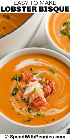 two white bowls filled with lobster soup and garnished with parsley on top