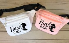 two fanny bags with the words mash bash printed on them, one in pink and one in white