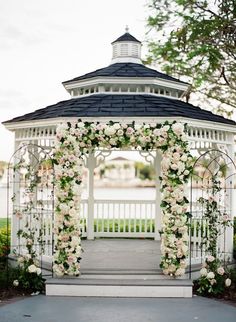 a white gazebo with flowers on it