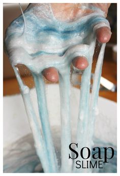 a person is pouring water into a bowl with blue and white icing on it