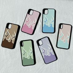 five iphone cases with designs on them sitting next to each other in different colors and shapes