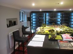 a room filled with lots of different types of toys and books on top of a table