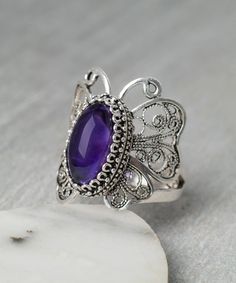 Amethyst Ruby Amber Blue Chalcedony Rainbow Quartz Butterfly Ring 925 Sterling Silver Artisan Crafted Filigree Ring Women Jewelry Gift Boxed Material: 925 Sterling Silver Genuine Gemstone: Choice of Amethyst, Ruby Corundum, Amber, Blue Chalcedony or Rainbow Quartz, 14 mm x 7 mm oval, total carat weights from 1 to 3 carats depending on the gemstone. Ring Face Length: 1 inches Comes with a gift pouch and box Free Domestic Shipping Butterfly is symbol of rebirth, resurrection, strength. It is hand Silver Filigree Amethyst Ring, Silver Sterling Silver Amethyst Ring With Filigree, Silver Filigree Amethyst Ring In Sterling Silver, Purple Filigree Jewelry Gift, Purple Sterling Silver Filigree Rings, Butterfly Gemstone Ring For Gift, Purple Amethyst Ring With Filigree, Butterfly Shaped Gemstone Wedding Jewelry, Sterling Silver Filigree Rings In Purple