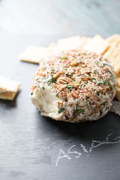 a cracker with cheese and nuts on it