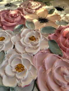 there is a cake decorated with pink and white flowers