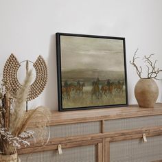 a painting is hanging on the wall above a dresser