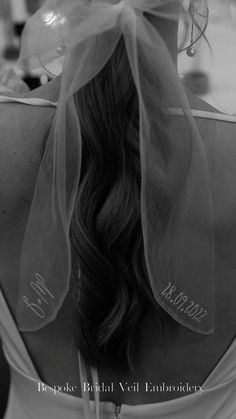 the back of a woman's head with a veil over her head and name on it