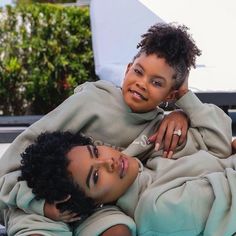 two children laying next to each other near a swimming pool