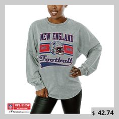 a woman wearing a new england football sweatshirt