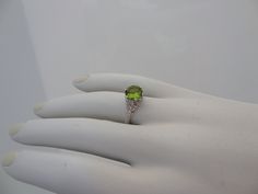 "We designed and handmade this ring. The center is a 8MM beautiful VVS Peridot 1.75 Cts . The Peridot is absolutely stunning. With 8 VS clarity side diamonds .14 Cts. It is made in 18k white gold. We can make it any size from 5-7 and you still be able to return it within the listed time frame. Sizing outside of that range makes it a FINAL SALE. We love this ring because it represents the way jewelry should be made with craftsmanship and quality. This ring is anything but ordinary. Our pieces are Luxury Peridot Jewelry For Formal Occasions, Luxury Peridot Ring For Formal Occasions, Luxury Oval Peridot Rings, Oval Peridot Diamond Ring For Formal Occasions, Peridot Rings With Brilliant Cut In Fine Jewelry Style, Fine Jewelry Peridot Rings With Brilliant Cut, Formal Oval Peridot Diamond Ring, Fine Jewelry Peridot Gemstones For Formal Occasions, Luxury Hallmarked Peridot Jewelry