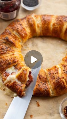 a pastry is being cut into pieces with a knife on the table next to it