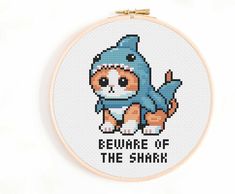 a cross stitch pattern with the words beware of the shark