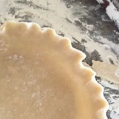 an uncooked pie crust sitting on top of a table