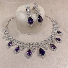 A beautiful Silver necklace set with bold Green Crystals & American Diamonds. Includes Earrings (approx 2 inch length) Perfect sparkly set for reception or engagement looks! Ready To Ship with gift box. Fancy Jewelry Set, Engagement Jewellery Set, Purple Necklace Set, Sparkly Set, Purple Jewelry Set, Engagement Looks, Purple Jewellery, Purple Stone Necklace, King Hat