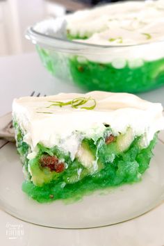 a piece of cake sitting on top of a white plate next to a glass bowl