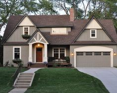 a gray house with white trim and brown roof