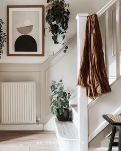 a white staircase with plants and pictures on the wall next to it that says 2 products