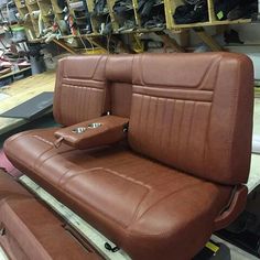 a brown leather seat sitting on top of a table