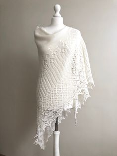 Hand knitted wedding shawl in pure merino wool. The Shawl is very soft and warm. You can wear it on any occassion. The Shawl looks great in any style you wear it. It can be a beautiful gift for a mom, wife, grandmother... Made to order. The shawl can be made in 10 days. Color - white Shape - triangle Fiber - merino wool 100% Measurements: lenght - 120 cm ( 47 inches) wide - 240 cm ( 94,5 inches) Care - hand wash in cool water and lay flat to dry, or dry clean. Elegant Wool Shawl Poncho, Elegant Wool Poncho Shawl, White Crochet Shawl For Winter, Winter White Crochet Shawl, Elegant White Poncho For Winter, Elegant White Winter Poncho, Elegant Hand Knitted Cream Shawl, White Crochet One-size Shawl, Elegant Hand Knitted Alpaca Shawl