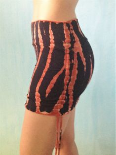 Our softest silkiest skirt, made from eco friendly rayon mixed with spandex, its super stretchy and form fits to your body's shape. Can be worn long, or cinch up the sides to make it shorter and tighter around your bum. Leave the top tall, or fold it over to customize fit. Fire tie dye is a gorgeous black with burnt orange streaks. Hand tied and dyed makes each one a unique wearable work of art. Will be similar to photos. Available in one size only, designed to be adjustable, fits most S/M. See Fitted Cotton Mini Skirt With Built-in Shorts, Fitted Hip-length Mini Skirt For Summer, Cotton Fitted Mini Skirt With Gathered Detail, Stretch Mini Skirt With Drawstring, Fitted Cotton Bottoms With Gathered Skirt, Fitted Yoga Bottoms With Drawstring, Fitted Drawstring Yoga Bottoms, Stretch Cotton Gathered Skirt Bottoms, Cotton Stretch Gathered Skirt Bottoms