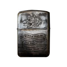 a zippo lighter with an image of a wolf on the side and words that read remain violent for the wolves drawn near it