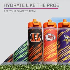 three different colored sports water bottles sitting on top of green grass with the words, hydrate like the pros rep your favorite team